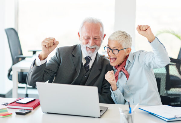 portrait of happy senior business people celebrating  in the office